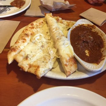 Moose's Tooth - Cheesy breadsticks (we already took a couple off the top) with house sauce.... so good!!! - Pizza Near Me - Anchorage, Alaska Moose's Tooth - Cheesy breadsticks (we already took a couple off the top) with house sauce.... so good!!! - Pizza Near Me - Anchorage, Alaska
