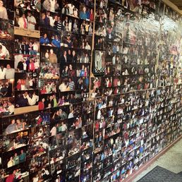 Wall of photos featuring Chef Jerome and customers.