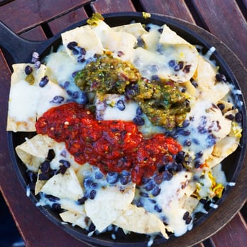 Grill Caliente - HOT SKILLET NACHOS $1O LAYERS OF CHIPS, BLACK BEANS, JACK CHEESE, SERVED IN A CAST-IRON SKILLET - New American Near Me - Ruidoso, New Mexico