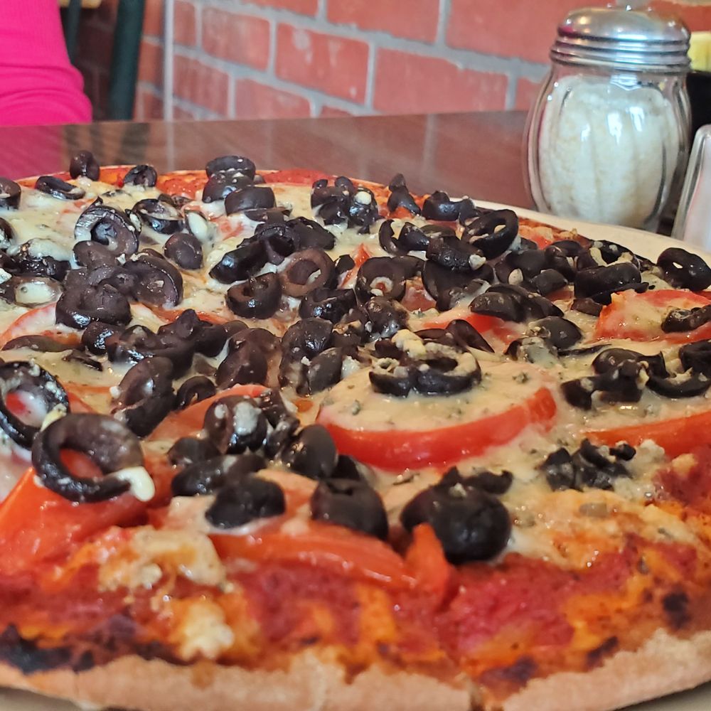 Lombardi's - Tomato and gorgonzola pizza, with olives. - Italian Near Me - Cambria, California