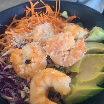 Organic Krush Kitchen & Eatery - Thai coconut shrimp bowl - A bowl contains cooked shrimp, shredded carrots, purple cabbage, and sliced avocado, served as a Thai coconut shrimp dish. - Juice Bars & Smoothies Near Me - Plainview, New York
