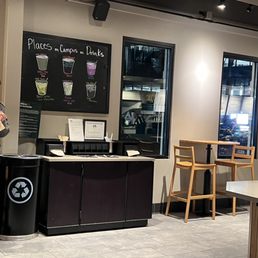 a man standing in a coffee shop a man standing in a coffee shop