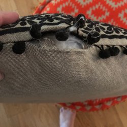 Dolma Tibetan Carpets - A hole shouldn't happen with the brand new poof. Disappointing. Double check the quality before you buy.