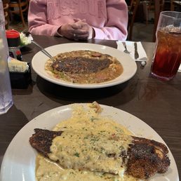 Blackened redfish, 2 ways: crawfish cream sauce and shrimp and grits, bowl in back Blackened redfish, 2 ways: crawfish cream sauce and shrimp and grits, bowl in back