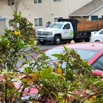 Signature Landscapes - a red car parked in front of a house - Landscaping Near Me Signature Landscapes - a red car parked in front of a house - Landscaping Near Me