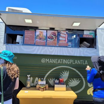 MANEATINGPLANT - a food truck with people standing in front of it - Food Trucks Near Me MANEATINGPLANT - a food truck with people standing in front of it - Food Trucks Near Me