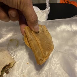 a hand holding a piece of food