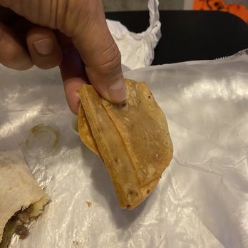 Harry's Long Bar - a hand holding a piece of food - Burgers Near Me - Blue Island, Illinois