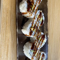 a plate of sushi with sauce and avocado a plate of sushi with sauce and avocado
