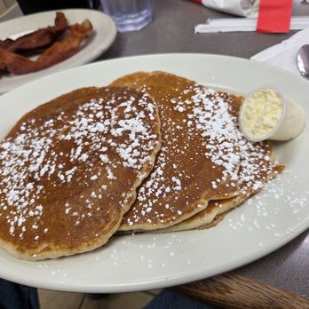 Maraschino Diner - Pancakes  with crispy bacon in the background - Waffles Near Me - Whitehall, Pennsylvania