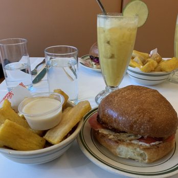 La Cubana - Yuca Frita, Achiote Chicken Sandwich, and Mango Colada Mocktail. - Cuban Near Me - Toronto, Ontario La Cubana - Yuca Frita, Achiote Chicken Sandwich, and Mango Colada Mocktail. - Cuban Near Me - Toronto, Ontario
