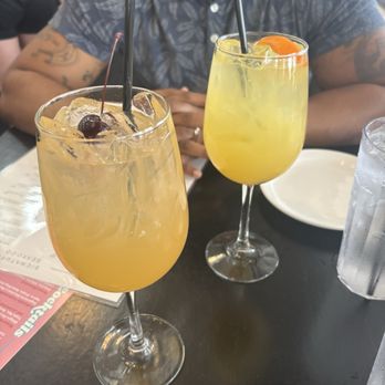Rick's Café Boatyard - Top (closer to husband): Bee Sting Bottom (with cherry): Peach Bellini Mocktini - American Near Me - Indianapolis, Indiana Rick's Café Boatyard - Top (closer to husband): Bee Sting Bottom (with cherry): Peach Bellini Mocktini - American Near Me - Indianapolis, Indiana