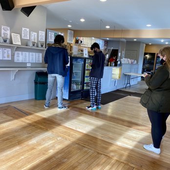 Bagels Plus - Take out set up. Arrows on the floor, 6 foot separations delineated. Hand sanitizer available & masks  worn & required. - Bagels Near Me - Acton, Massachusetts