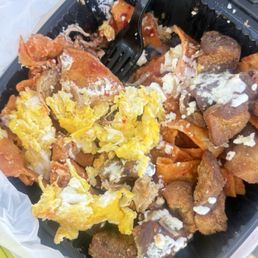 Red chilaquiles, carnitas and chicharrón. Scrambled eggs Red chilaquiles, carnitas and chicharrón. Scrambled eggs