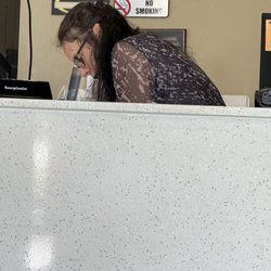 A full trash can just waiting to be emptied.. the picture of the "front desk" person..