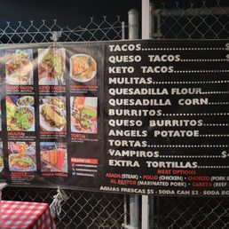 a menu for tacoss on a fence