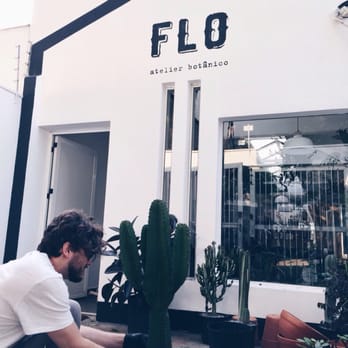 FLO Atelier Botânico - Owner Jotta caring for one of his beloved cacti. - Nurseries & Gardening Near Me - São Paulo, SP