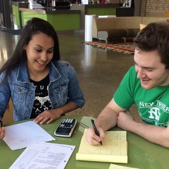 Eclipse Tutoring - David, one of our tutors, helping a student with math at the Richland Public Library. - Tutoring Centers Near Me