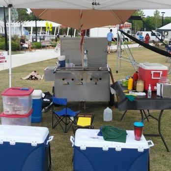 Thrashers Dawgs - a bbq and coolers under a tent - Food Trucks Near Me