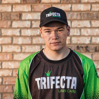 Trifecta Landscaping - a man in a black and green shirt and cap - Lawn Services Near Me - Irmo, South Carolina Trifecta Landscaping - a man in a black and green shirt and cap - Lawn Services Near Me - Irmo, South Carolina