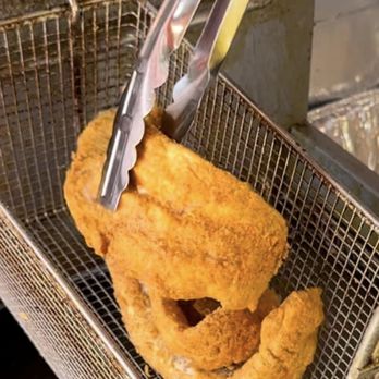 Just Fish - a person using a pair of tongs to fry a fish - Food Trucks Near Me - Lebanon, Tennessee