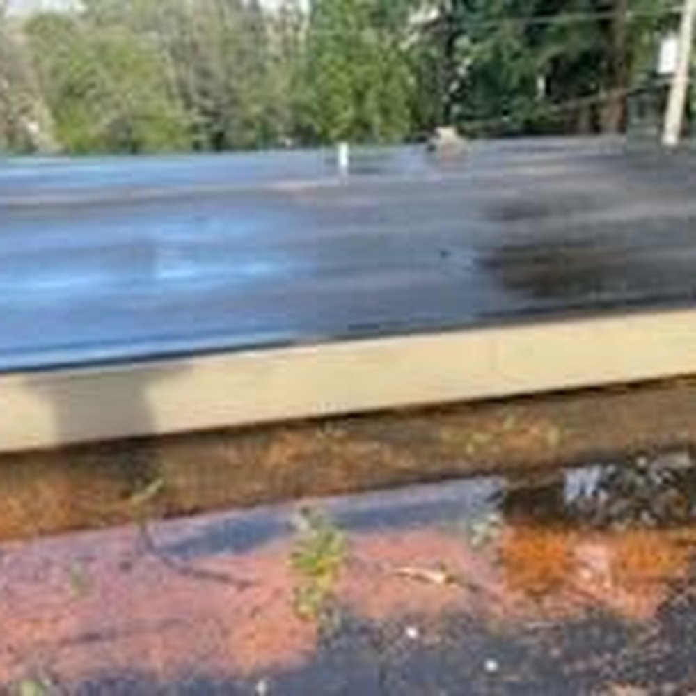 Right Choice Roofing - Debris on flat roof with cleaned roof in background - Roofing Near Me - Arlington, Washington Right Choice Roofing - Debris on flat roof with cleaned roof in background - Roofing Near Me - Arlington, Washington