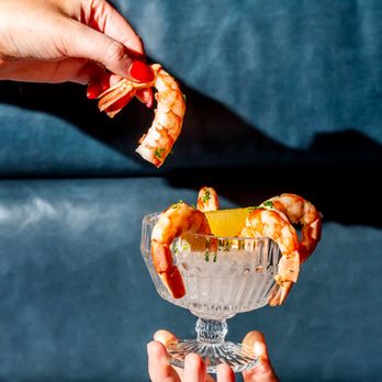 The Joneses - a person holding a glass of shrimp - American Near Me - Toronto, Ontario The Joneses - a person holding a glass of shrimp - American Near Me - Toronto, Ontario