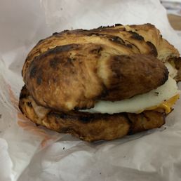 a croissant sandwich on a piece of wax paper a croissant sandwich on a piece of wax paper