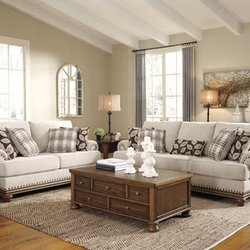 Interior Furniture Resources - True classic character comes to life in the Harleson sofa and loveseat set. Setback pleated roll arms and warm brown exposed frame with bun