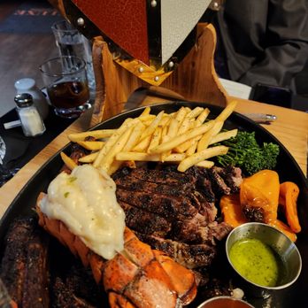 Deluxe Fun Dining - Steak, lobster tail, broccolini & fries - Bars Near Me - Charlotte, North Carolina