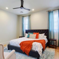Modern Bedroom of Maison Rougaroux with (02) Tufted Recliners for relaxing & finished in Cool Colors