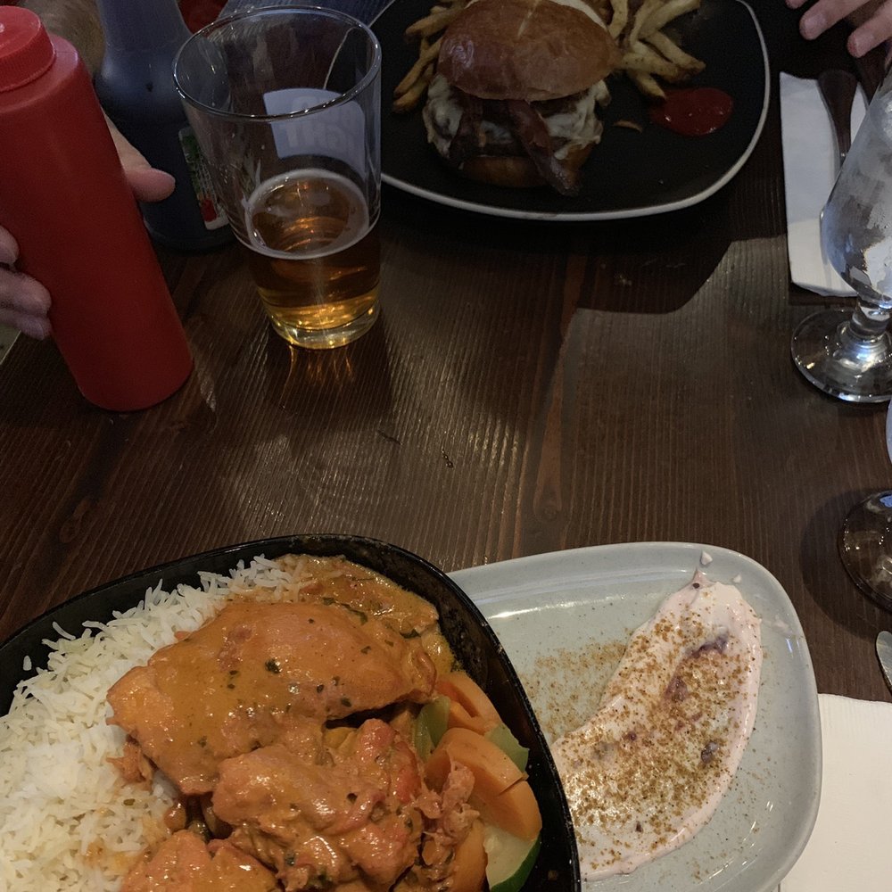 Graze - Butter chicken bowl (close) and an Old School ell burger (far). - Bars Near Me - Canmore, Alberta Graze - Butter chicken bowl (close) and an Old School ell burger (far). - Bars Near Me - Canmore, Alberta