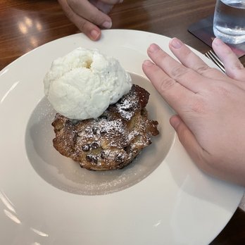 Aurora At The Celeste - Bread pudding with hand for scale - American Near Me - Orlando, Florida