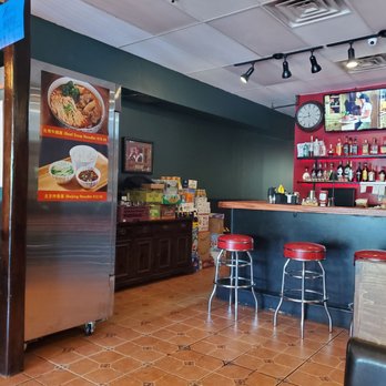 Kai Burgers & Dumplings - Inside bar area with new menu items on drink fridge. - New American Near Me - Great Neck, New York
