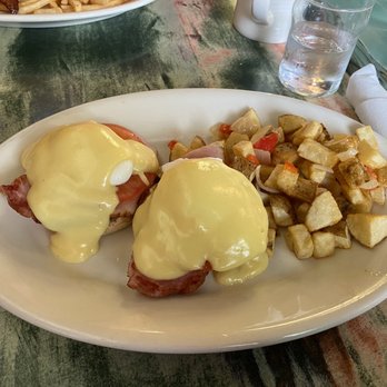 Meridian Cafe - Eggs Benedict (with a slice of tomato in the stack)with home-fries - Breakfast & Brunch Near Me - Puyallup, Washington Meridian Cafe - Eggs Benedict (with a slice of tomato in the stack)with home-fries - Breakfast & Brunch Near Me - Puyallup, Washington