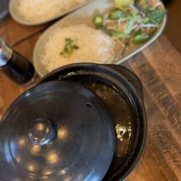 a pot of sushi and a plate of rice a pot of sushi and a plate of rice