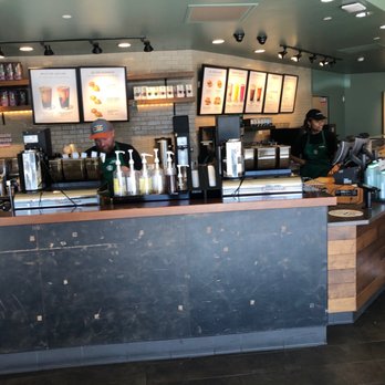 Starbucks - a man standing at the counter of a coffee shop - Coffee & Tea Near Me - Roswell, Georgia Starbucks - a man standing at the counter of a coffee shop - Coffee & Tea Near Me - Roswell, Georgia