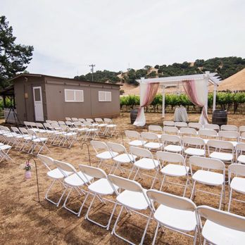 Seeker Vineyard - rows of white folding chairs set up for a wedding ceremony - Wineries Near Me - San Martin, California Seeker Vineyard - rows of white folding chairs set up for a wedding ceremony - Wineries Near Me - San Martin, California