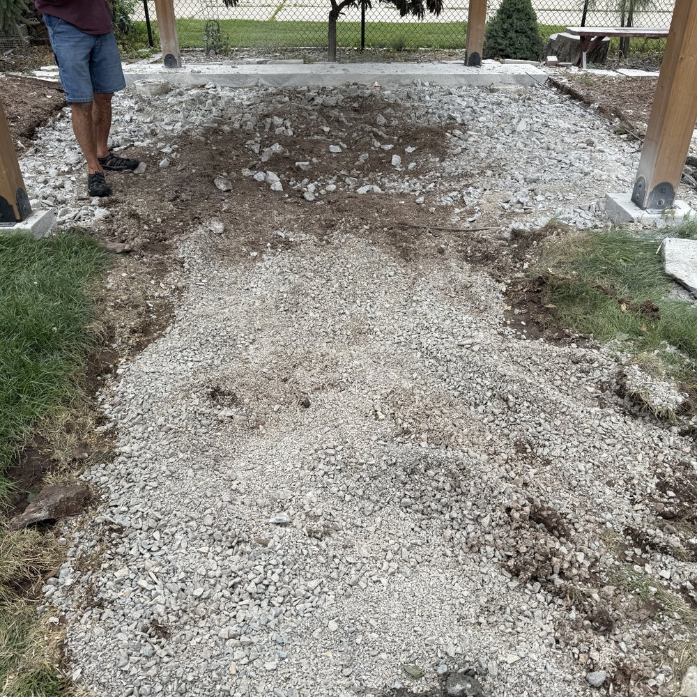 Valley Peak Construction - The flagstone pathway used to be where the gravel is. Beyond that is after the cement was broken up with the jack hammer and never removed - Masonry/Concrete Near Me - Appleton, Wisconsin