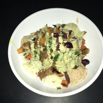 CAVA - Rice bowl with the braised lamb, hummus, eggplant and red pepper dip, veggies, kalamata olives and the lemon herb tahini - Mediterranean Near Me - San Diego, California