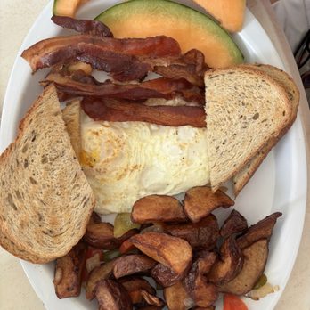 The Dune Deck Cafe - Egg over easy with bacon, fresh fruit and rye bread - Breakfast & Brunch Near Me - Lantana, Florida The Dune Deck Cafe - Egg over easy with bacon, fresh fruit and rye bread - Breakfast & Brunch Near Me - Lantana, Florida