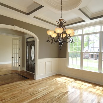 Diverse Homes - an empty living room with a chandelier - General Contractors Near Me Diverse Homes - an empty living room with a chandelier - General Contractors Near Me