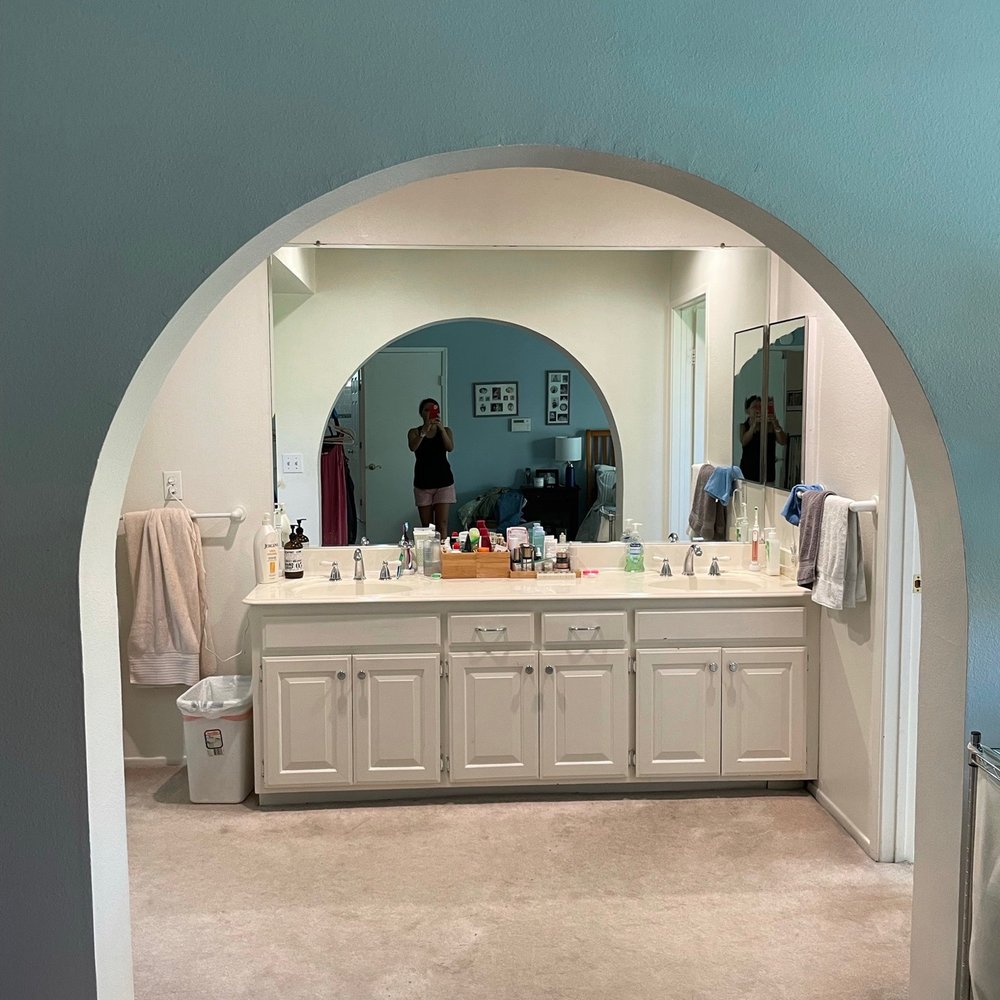 Upend Manor Renovation - a bathroom with a large mirror - General Contractors Near Me - Santa Ana, California Upend Manor Renovation - a bathroom with a large mirror - General Contractors Near Me - Santa Ana, California
