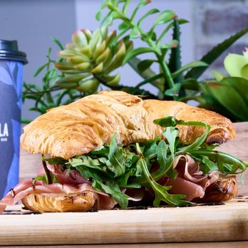 Carmela Coffee - Wellington - Prosciutto & Swiss croissant at Carmela Coffee Wellington with a buttery croissant, prosciutto, Swiss cheese, arugula, and ba... - Coffee & Tea Near Me - Wellington, Florida Carmela Coffee - Wellington - Prosciutto & Swiss croissant at Carmela Coffee Wellington with a buttery croissant, prosciutto, Swiss cheese, arugula, and ba... - Coffee & Tea Near Me - Wellington, Florida