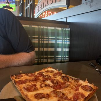 Buddy's Pizza - Woodhaven - a slice of pizza on a plate - Pizza Near Me - Woodhaven, Michigan Buddy's Pizza - Woodhaven - a slice of pizza on a plate - Pizza Near Me - Woodhaven, Michigan