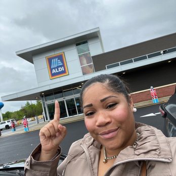 ALDI - a woman holding up a peace sign - Grocery Near Me - La Plata, Maryland