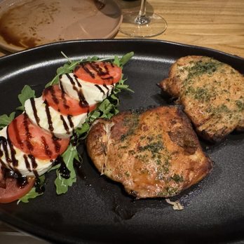 Capriccio - Pesto chicken dish with caprese arugula salad - Italian Near Me - Miami, Florida Capriccio - Pesto chicken dish with caprese arugula salad - Italian Near Me - Miami, Florida