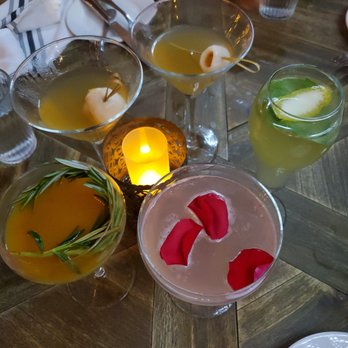 Poor Calvin's - Mango Spice is the one on the left garnished with rosemary sprigs - Asian Fusion Near Me - Atlanta, Georgia Poor Calvin's - Mango Spice is the one on the left garnished with rosemary sprigs - Asian Fusion Near Me - Atlanta, Georgia