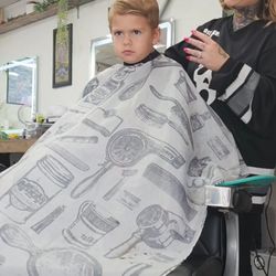 36th Street Barbershop - Maci cutting owens hair