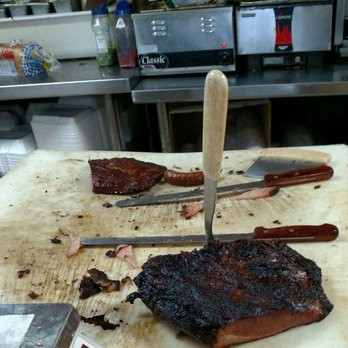 Lockhart Chisholm Trail BBQ - Side of brisket on the carving board - Barbeque Near Me - Lockhart, Texas